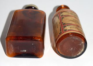 Two Vintage Amber Glass Medicine Bottles With Their Labels photo