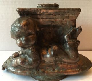 Metal Copper Toy Factory Mold - Child Lying In Front Of Fireplace photo