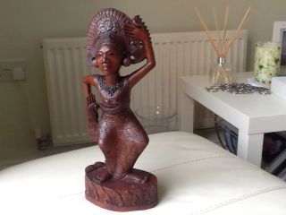 Carved Wooden Statue Of Woman photo