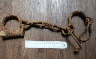 Very Rare Old Ancient Forged Viking Shackles On A Foot. photo