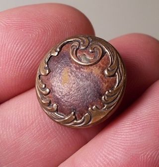 Antique Art Nouveau Brass Button With Leather Insert Background photo