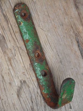 Vintage Industrial Wrought Iron Beam Hook With Old Flaky Paint Worn Wooden Aged photo
