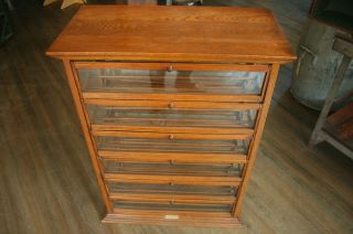A.  N.  Russell & Sons: Antique Oak Ribbon Display Cabinet photo